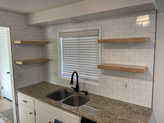 Floating shelves installed in a kitchen